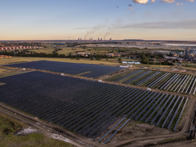 The Evander solar park in the foreground. Industrial facilities can be seen on the horizon.